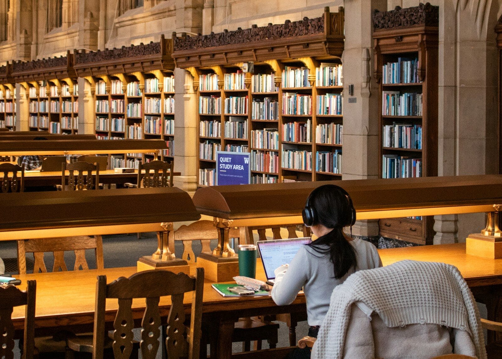 A student studies in a large, old library.
